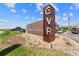 The Green Valley Ranch community entrance sign for the Smokehouse and Oyster Bar with a beautiful blue sky at 19131 E 65Th Ave, Denver, CO 80249