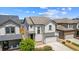 Charming two-story home with a light gray exterior, a two-car garage, and professional landscaping at 19131 E 65Th Ave, Denver, CO 80249