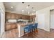 Bright kitchen features stainless appliances, granite countertops, pendant lighting, and breakfast bar seating at 19131 E 65Th Ave, Denver, CO 80249