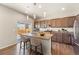 Modern kitchen with stainless steel appliances, granite countertops, and island with seating at 19131 E 65Th Ave, Denver, CO 80249