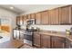 The kitchen is equipped with stainless appliances, granite countertops, and lovely wood flooring at 19131 E 65Th Ave, Denver, CO 80249