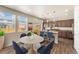 The open kitchen features stainless appliances, granite countertops, pendant lighting, and breakfast bar seating at 19131 E 65Th Ave, Denver, CO 80249