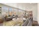 Open living room with lots of natural light, view to the kitchen and dining room, and modern furnishings at 19131 E 65Th Ave, Denver, CO 80249