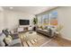 Beautiful living room with comfortable seating, a media center, and plenty of natural light at 19131 E 65Th Ave, Denver, CO 80249