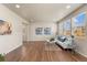Open floorplan living room features hardwood floors, recessed lighting, and large windows providing lots of natural light at 19131 E 65Th Ave, Denver, CO 80249