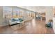 A spacious living room blends into an open-concept kitchen, and features bright windows and wood-style floors at 19131 E 65Th Ave, Denver, CO 80249