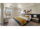 Spacious main bedroom with a tray ceiling, modern decor, and large windows for natural light at 19131 E 65Th Ave, Denver, CO 80249