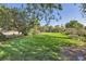 Expansive green back yard with mature trees, well-kept lawn, and landscaping at 5480 S Holly St, Greenwood Village, CO 80111