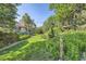 Spacious backyard features a lush lawn, mature trees, and a charming treehouse at 5480 S Holly St, Greenwood Village, CO 80111