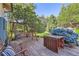 Secluded backyard with a wooden deck, swing, mature trees and lush landscaping at 5480 S Holly St, Greenwood Village, CO 80111