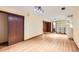Unfinished basement with track lighting, wood-look floors, closet, and shelving unit with storage boxes at 5480 S Holly St, Greenwood Village, CO 80111
