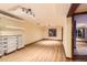 Spacious basement with shelving and vinyl flooring providing ample storage and living space at 5480 S Holly St, Greenwood Village, CO 80111