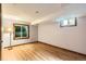Basement bedroom with natural light from two windows and wood-look flooring at 5480 S Holly St, Greenwood Village, CO 80111