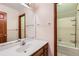 Bright bathroom with single sink vanity, towel rack, and tub/shower combo at 5480 S Holly St, Greenwood Village, CO 80111