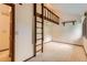 Large carpeted bedroom with loft area and side windows providing natural light at 5480 S Holly St, Greenwood Village, CO 80111
