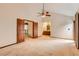 Spacious bedroom with vaulted ceiling, ceiling fan, carpet, and an adjoining bathroom at 5480 S Holly St, Greenwood Village, CO 80111