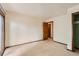 Carpeted bedroom with a sliding glass door, closet, and neutral-toned walls at 5480 S Holly St, Greenwood Village, CO 80111
