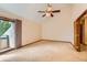 Generous bedroom with balcony access and an en-suite bathroom, featuring vaulted ceilings at 5480 S Holly St, Greenwood Village, CO 80111