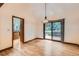 Dining room with hardwood floors, access to deck and adjoining kitchen at 5480 S Holly St, Greenwood Village, CO 80111