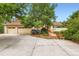 Inviting home featuring a red tile roof, mature landscaping, and an attached two-car garage at 5480 S Holly St, Greenwood Village, CO 80111