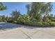 Well-maintained front yard with lush greenery, manicured bushes, and a paved driveway on a sunny day at 5480 S Holly St, Greenwood Village, CO 80111
