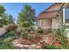 Manicured garden featuring stone walkways, red mulch, and lush greenery at 5480 S Holly St, Greenwood Village, CO 80111