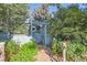 Inviting garden gate surrounded by lush greenery, flowers, and a charming wooden fence at 5480 S Holly St, Greenwood Village, CO 80111