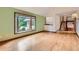 Bright living area featuring a large bay window and hardwood floors at 5480 S Holly St, Greenwood Village, CO 80111