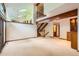 Spacious living room with wooden beams, staircase, a chandelier, and a sliding glass door at 5480 S Holly St, Greenwood Village, CO 80111
