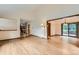Spacious living area with hardwood floors, open layout, and sliding glass doors to the deck at 5480 S Holly St, Greenwood Village, CO 80111