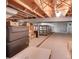 Unfinished basement with storage shelves and gray concrete walls, offering ample space at 1019 24Th St, Golden, CO 80401