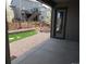View of the backyard with patio, landscaped area, and fenced yard at 4580 S Ukraine Cir, Aurora, CO 80015