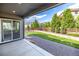 Inviting backyard with a patio, gravel area, grass, and a wood fence at 4580 S Ukraine Cir, Aurora, CO 80015