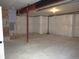 Spacious unfinished basement with concrete floor and exposed support beams at 4580 S Ukraine Cir, Aurora, CO 80015