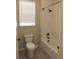 Clean bathroom with white tile, a tub/shower combo, and modern fixtures at 4580 S Ukraine Cir, Aurora, CO 80015