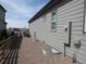 Side exterior view of home showing backyard access and utility connections at 4580 S Ukraine Cir, Aurora, CO 80015