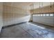 Empty garage with concrete flooring and an automated overhead door at 4580 S Ukraine Cir, Aurora, CO 80015