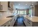 Bright kitchen showcasing a stainless steel range hood, white countertops, and modern cabinetry at 4580 S Ukraine Cir, Aurora, CO 80015