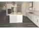 Modern kitchen features a center island, white cabinets, and stainless steel appliances at 4580 S Ukraine Cir, Aurora, CO 80015