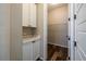 Functional laundry room with white cabinets and shelving for storage at 4580 S Ukraine Cir, Aurora, CO 80015