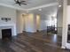 Spacious living room with dark hardwood floors and a modern fireplace at 4580 S Ukraine Cir, Aurora, CO 80015