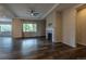 Bright living room featuring a fireplace, ceiling fan, and a large window at 4580 S Ukraine Cir, Aurora, CO 80015