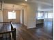 Open living space boasting wood floors, modern lighting, and seamless access to the kitchen area at 4580 S Ukraine Cir, Aurora, CO 80015