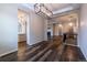 Expansive living space featuring wood floors, recessed lights, modern fixtures, and a cozy fireplace at 4580 S Ukraine Cir, Aurora, CO 80015