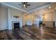 Spacious living room featuring a fireplace, recessed lighting, and wood floors with a smooth transition to hallway at 4580 S Ukraine Cir, Aurora, CO 80015