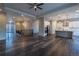 Open-concept living space connecting the foyer, living room, and kitchen with stylish wood flooring at 4580 S Ukraine Cir, Aurora, CO 80015