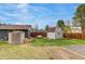 Spacious backyard featuring two storage sheds, a wooden fence, and well-maintained lawn at 3402 S Olathe Way, Aurora, CO 80013