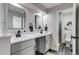 Modern bathroom featuring double vanity with black hardware, and a separate water closet with decorative art at 3402 S Olathe Way, Aurora, CO 80013