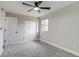 Bright bedroom with neutral walls and carpet, modern ceiling fan, and ample closet space creating a cozy atmosphere at 3402 S Olathe Way, Aurora, CO 80013