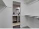 Walk-in closet with neutral carpet and white closet system providing ample storage space with access to the bathroom at 3402 S Olathe Way, Aurora, CO 80013